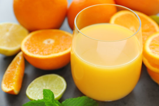 Glass of fresh orange juice on table, closeup