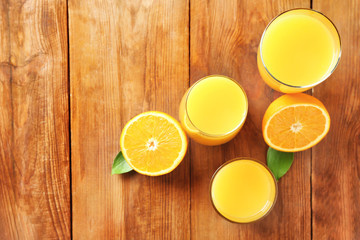 Glasses with fresh orange juice on table