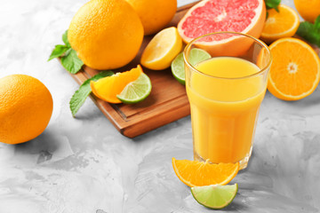 Glass of fresh orange juice on table