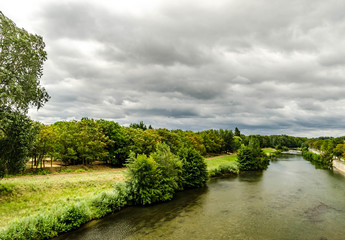 Fototapeta na wymiar landscape with river, trees and cloudy sky