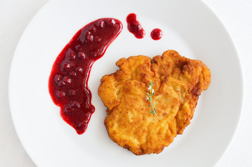 turkey schnitzel with wild berries sauce decorated with thyme