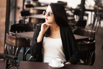 Young girl drinking black coffee