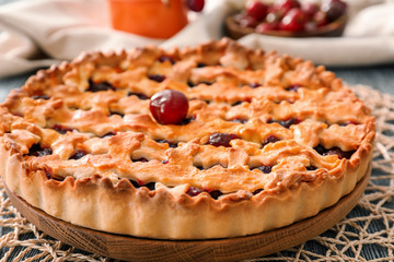 Delicious cherry pie on table
