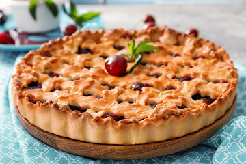 Delicious cherry pie on table