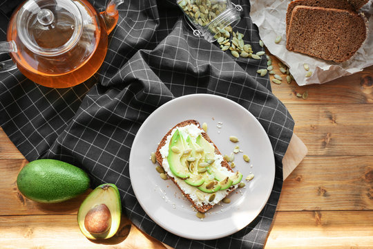 Composition with delicious toast and avocado on plate