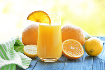 Fototapeta na wymiar Glass with delicious orange juice on table