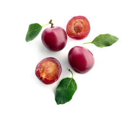 Ripe fresh plums on white background