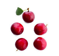 Ripe fresh plums on white background