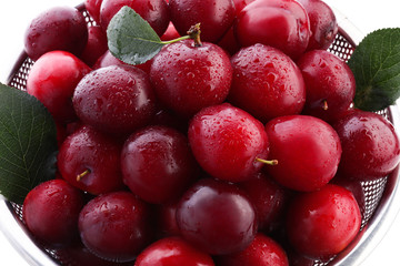 Closeup of ripe fresh plums in colander