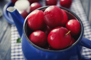 Closeup of ripe fresh plums in teapot