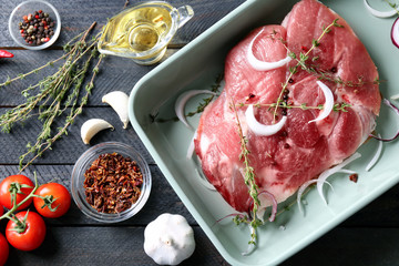 Baking dish with fresh raw steak on table