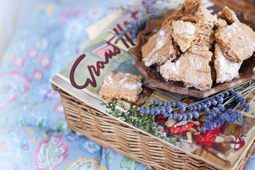 Almond cookies for breakfast. on a wicker basket. magazine and lavender. in the gentle Shebi style. on blue pillows