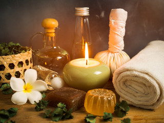 Obraz na płótnie Canvas Spa massage items in candlelight,aroma oil and herbal ball.