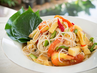 Spicy papaya salad with rice noodle or somtum famous  traditional Thai food.