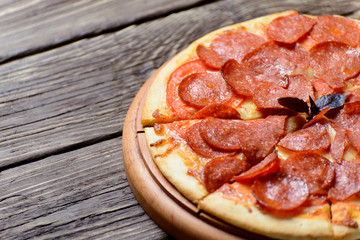 Homemade pepperoni pizza on a wooden Board