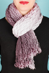 Silk scarf. Pink silk scarf around her neck isolated on blue background.