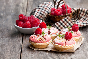 Raspberry  macaroon tarts on wooden table