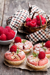 Raspberry  macaroon tarts on wooden table