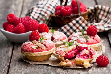 Raspberry  macaroon tarts on wooden table
