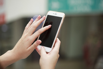 Close up, Beautiful female hands holding a mobile phone, indoor