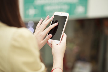 Close up, Beautiful female hands holding a mobile phone, indoor