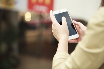 Close up, Beautiful female hands holding a mobile phone, indoor