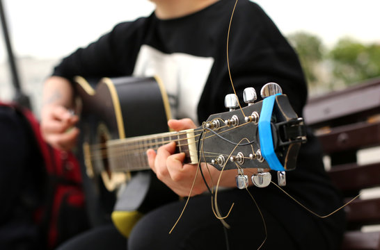 A street musician playing the guitar.