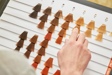 Hair dye sample chart, hand. Different colors of hair. © DenisProduction.com