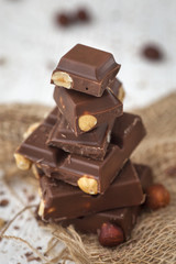 Chocolate bar with nuts on a wooden table