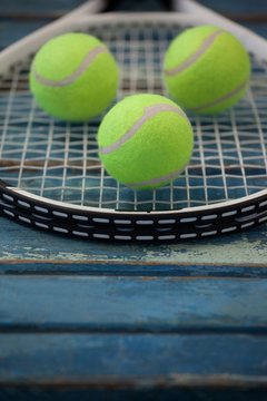 Close up of fluorescent yellow balls on tennis racket
