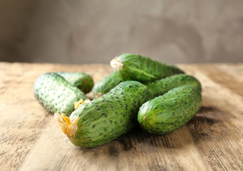 Many green fresh cucumbers on wooden table