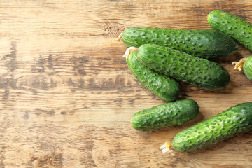 Many green fresh cucumbers on wooden table