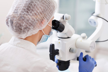 professional dentist examination patient with microscope at the office