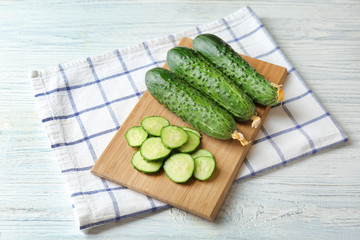Green fresh cucumbers on wooden board