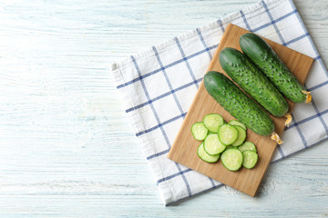 Green fresh cucumbers on wooden board