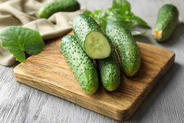 Green fresh cucumbers on wooden board