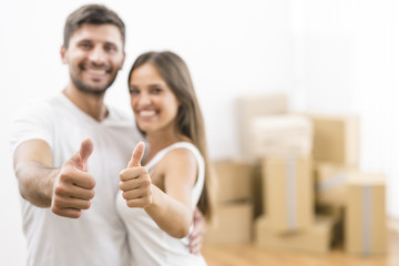 Fototapeta premium The happy woman and man gesture on the background of the carton boxes