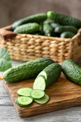 Green fresh cucumbers on wooden board