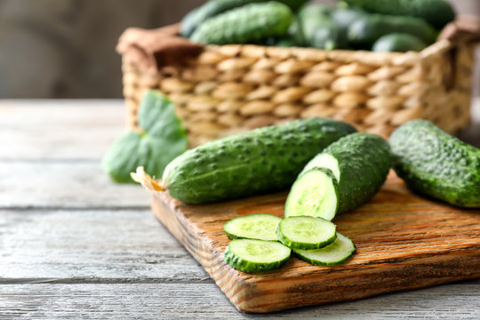 Green fresh cucumbers on wooden board
