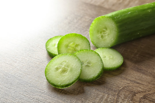 Fresh sliced cucumber on wooden table