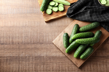 Green fresh cucumbers on wooden board