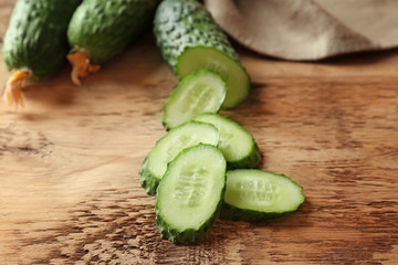 Fresh sliced cucumber on wooden table