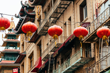 chinese lanterns and fire escape stairs at background - obrazy, fototapety, plakaty