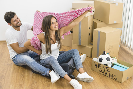 The happy couple fun on the background of the carton boxes