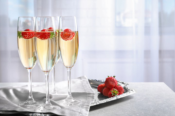Glasses of delicious wine with strawberry on table © Africa Studio