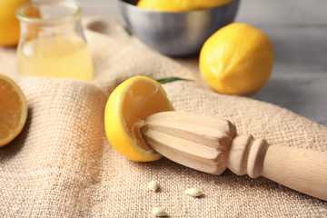 Wooden lemon squeezer on table