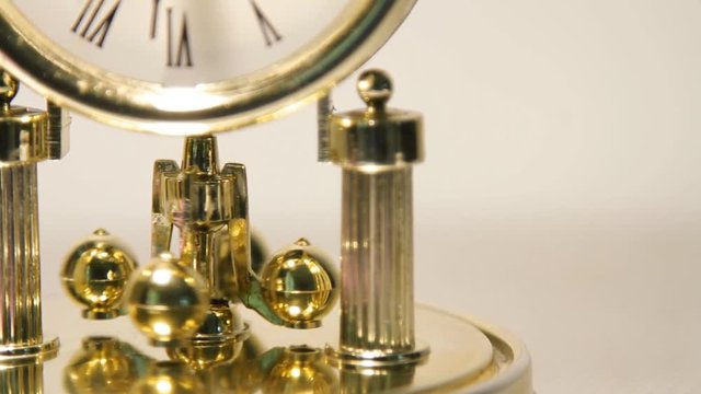 Time management concept table clock Put an antique battery over white background.