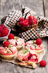 Raspberry  macaroon tarts on wooden table