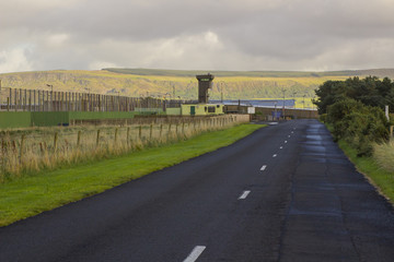 Fototapeta premium 12 September 2017 The high observation towers and security fencing at the entrance to the Magilligan Prison in County Londonderry on the North Coast of Ireland