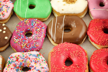 Bright and colorful donuts close-up in a box